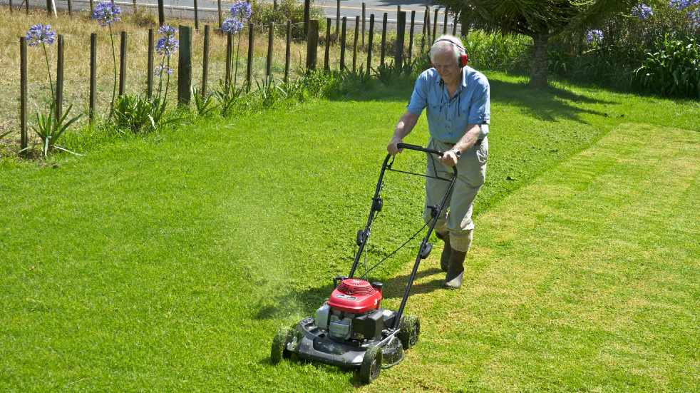 Lawn maintenance tips man mowing lawn